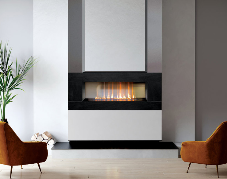 Linear gas fireplace burning behind glass in a black surround, set into a white chimney breast between two armchairs